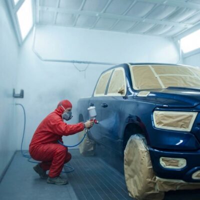 Blue Dodge truck in paint booth-Paint Repair Sherrill Paint & Body